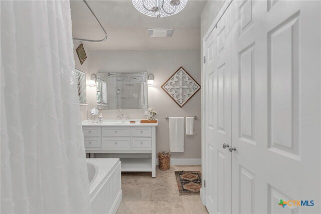 bathroom featuring a shower with shower curtain, vanity, and an inviting chandelier