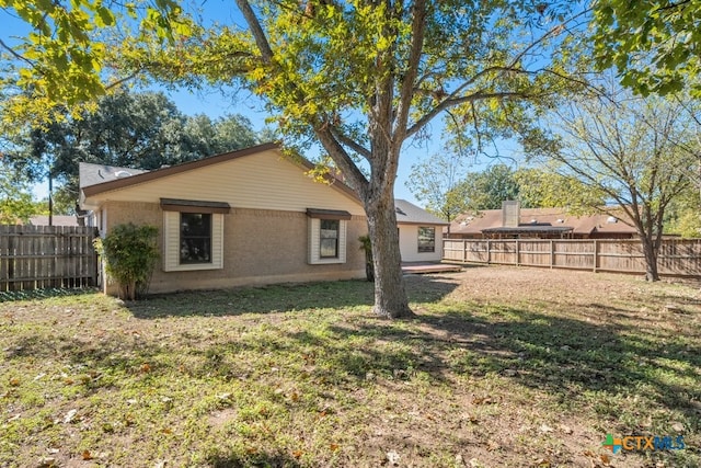 rear view of house with a yard