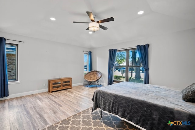 bedroom with light wood-type flooring, vaulted ceiling, and ceiling fan