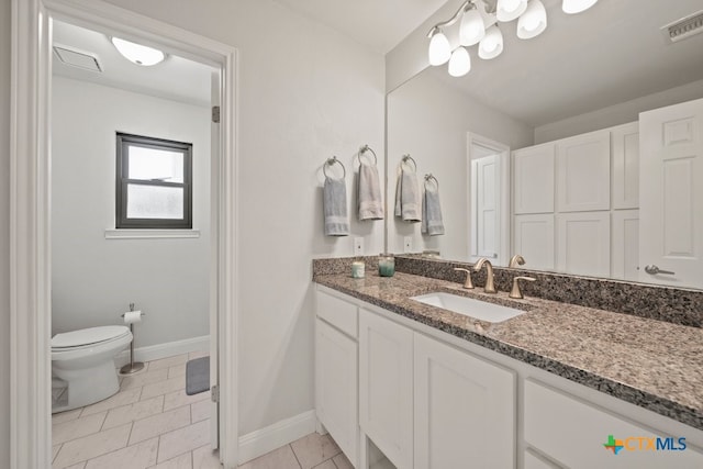 bathroom featuring tile patterned floors, vanity, and toilet