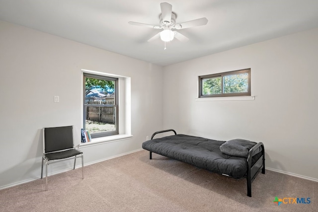 sitting room with carpet flooring, plenty of natural light, and ceiling fan