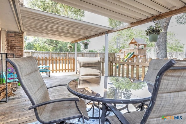 418 Taos Dr, Victoria, TX 77904 - wooden deck with a playground and outdoor dining area