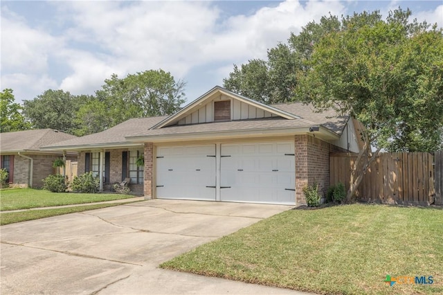 418 Taos Dr, Victoria, TX 77904 - view of front of property with brick siding, a garage, concrete driveway, board and batten siding, and a shingled roof