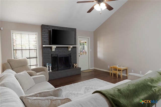 418 Taos Dr, Victoria, TX 77904 - living room featuring wood finished floors, a ceiling fan, a brick fireplace, baseboards, and vaulted ceiling