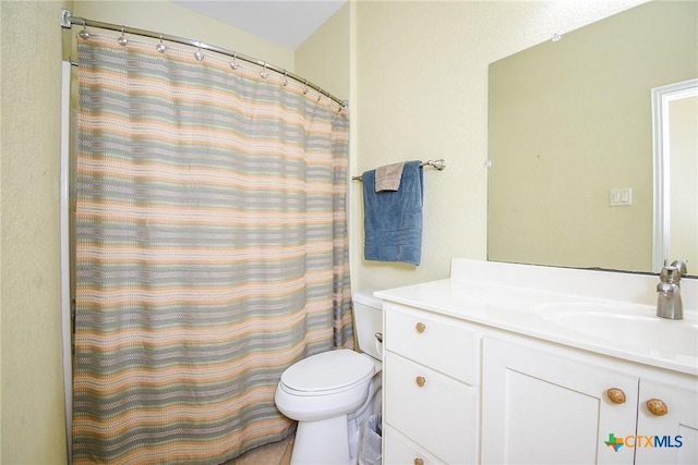 1588 W Bayshore Dr, Palacios, TX 77465 - bathroom with toilet, vanity, and a shower with curtain