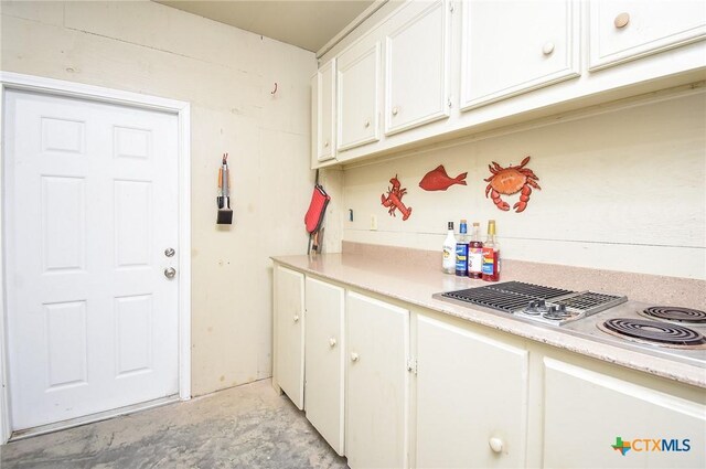 1588 W Bayshore Dr, Palacios, TX 77465 - kitchen featuring light countertops, stainless steel electric stovetop, and white cabinetry