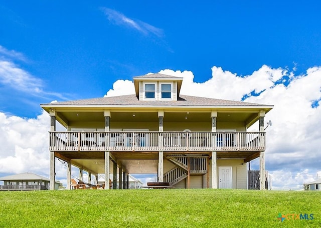 1588 W Bayshore Dr, Palacios, TX 77465 - back of house featuring stairs, a deck, and a lawn