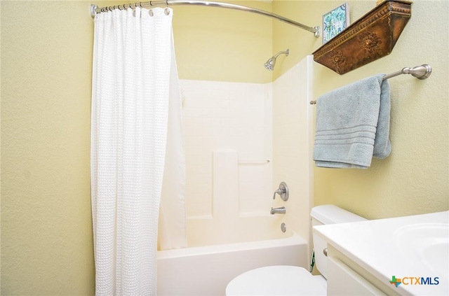 1588 W Bayshore Dr, Palacios, TX 77465 - bathroom with toilet, shower / tub combo with curtain, a textured wall, and vanity