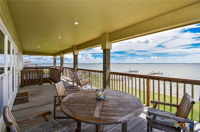 1588 W Bayshore Dr, Palacios, TX 77465 - wooden terrace featuring a water view and outdoor dining area