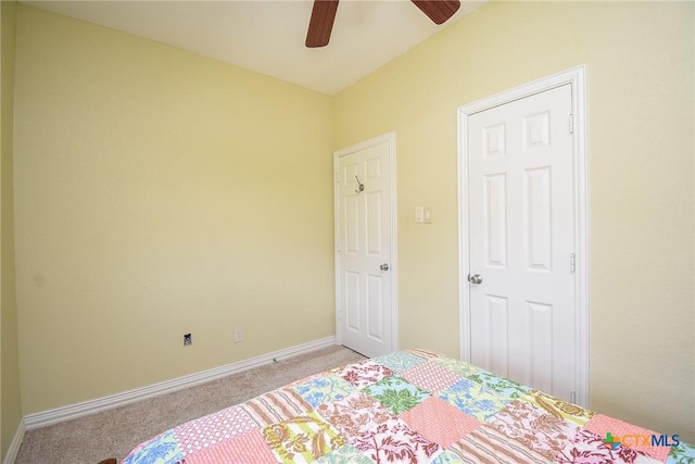 1588 W Bayshore Dr, Palacios, TX 77465 - carpeted bedroom with baseboards and ceiling fan
