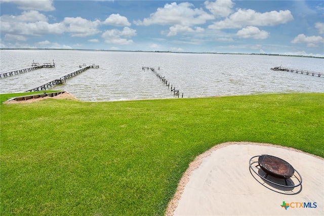 1588 W Bayshore Dr, Palacios, TX 77465 - dock area with a fire pit, a water view, and a yard