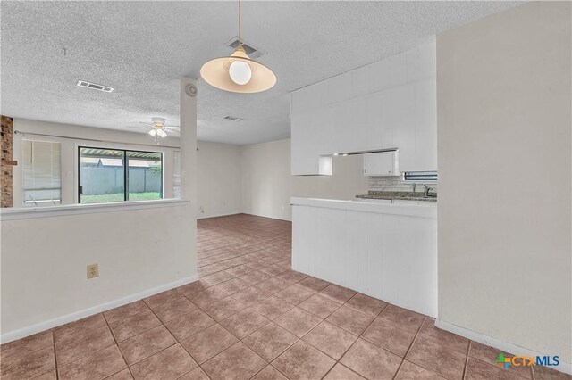 1123 Rhonda Lee St, Copperas Cove, TX 76522 - unfurnished room with a textured ceiling, a ceiling fan, light tile patterned floors, baseboards, and a sink