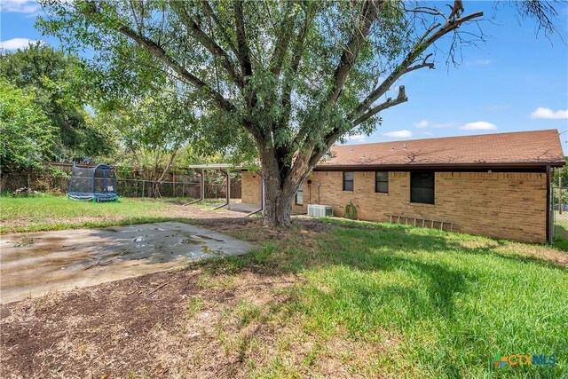 1123 Rhonda Lee St, Copperas Cove, TX 76522 - view of yard featuring a trampoline, a patio, and central air condition unit