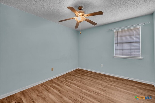 spare room featuring a textured ceiling, ceiling fan, and light hardwood / wood-style flooring