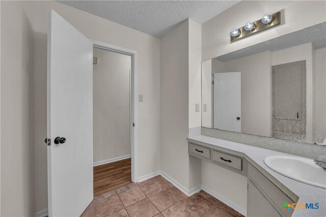 1123 Rhonda Lee St, Copperas Cove, TX 76522 - bathroom featuring vanity, a textured ceiling, and baseboards
