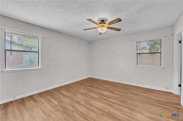 1123 Rhonda Lee St, Copperas Cove, TX 76522 - empty room with a ceiling fan, a textured ceiling, healthy amount of natural light, light wood finished floors, and baseboards