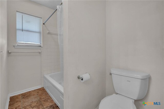 1123 Rhonda Lee St, Copperas Cove, TX 76522 - full bathroom featuring toilet, baseboards, shower / bath combination with curtain, and stone finish floors