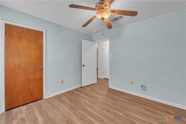 1123 Rhonda Lee St, Copperas Cove, TX 76522 - unfurnished bedroom with wood finished floors, a textured ceiling, baseboards, and ceiling fan