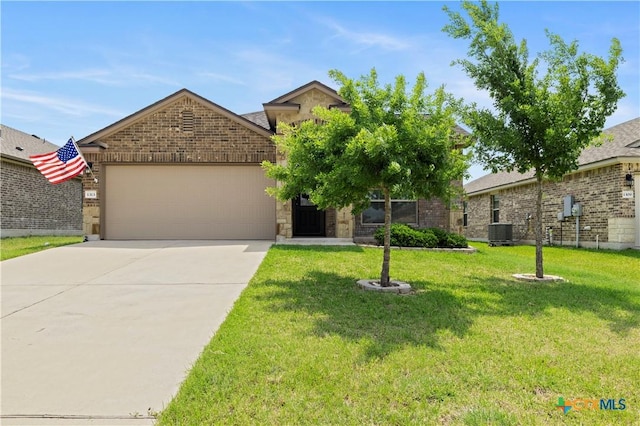 1313 Juneberry Park Dr, Temple, TX 76502 - view of front of house with central AC, driveway, a garage, a front lawn, and brick siding