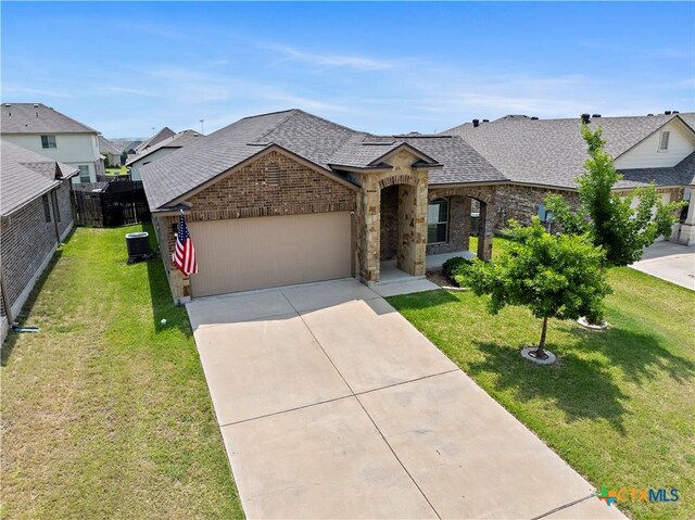 1313 Juneberry Park Dr, Temple, TX 76502 - french country style house featuring a shingled roof, a garage, brick siding, and driveway