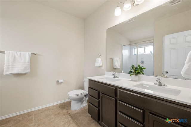 1313 Juneberry Park Dr, Temple, TX 76502 - full bath with double vanity, toilet, baseboards, a shower with shower door, and tile patterned floors