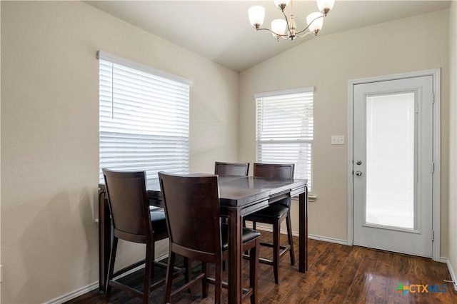 1313 Juneberry Park Dr, Temple, TX 76502 - dining area with a chandelier, vaulted ceiling, dark wood-type flooring, and baseboards