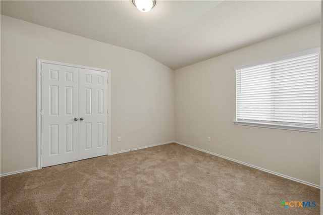 1313 Juneberry Park Dr, Temple, TX 76502 - unfurnished bedroom featuring carpet flooring, vaulted ceiling, a closet, and baseboards