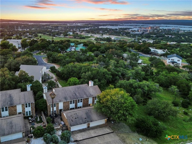 aerial view at dusk with a water view