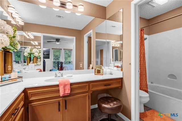 full bathroom with ceiling fan, a textured ceiling, toilet, vanity, and shower / tub combo