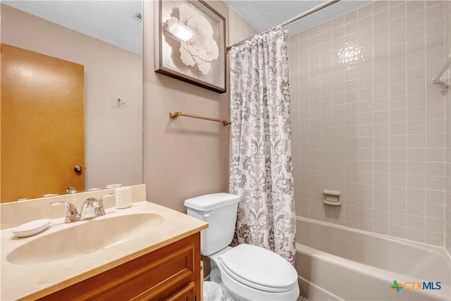 full bathroom featuring vanity, shower / bath combo, a textured ceiling, and toilet