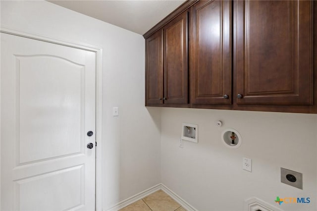 215 Maverick Cir, Horseshoe Bay, TX 78657 - washroom with electric dryer hookup, hookup for a gas dryer, cabinet space, washer hookup, and light tile patterned floors