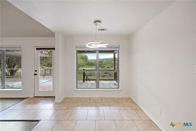 215 Maverick Cir, Horseshoe Bay, TX 78657 - unfurnished dining area featuring light tile patterned flooring and a chandelier