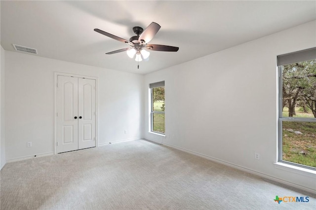 215 Maverick Cir, Horseshoe Bay, TX 78657 - unfurnished bedroom with carpet, a closet, and ceiling fan