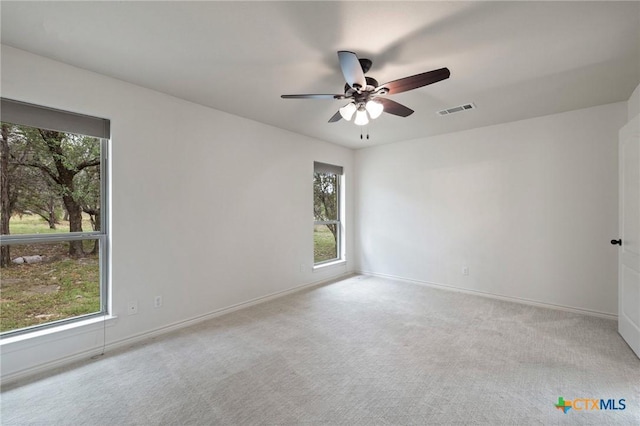 215 Maverick Cir, Horseshoe Bay, TX 78657 - carpeted empty room with healthy amount of natural light and a ceiling fan