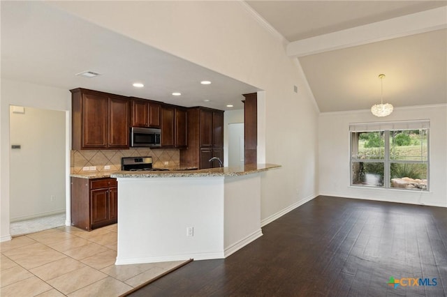 215 Maverick Cir, Horseshoe Bay, TX 78657 - kitchen featuring stainless steel appliances, light stone countertops, decorative backsplash, ornamental molding, and dark brown cabinetry
