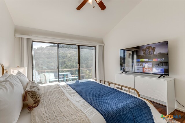 bedroom featuring dark wood finished floors, access to outside, vaulted ceiling, and ceiling fan