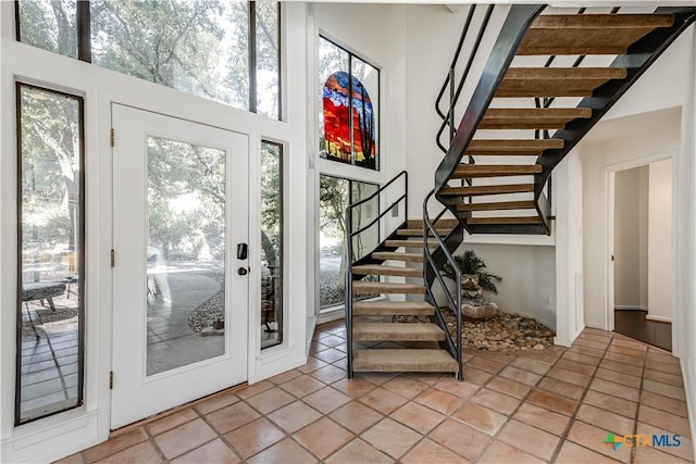 2701 Hillside Cir, New Braunfels, TX 78132 - entrance foyer with stairway, a high ceiling, and light tile patterned flooring