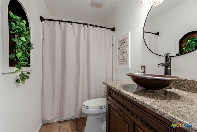 full bath with tile patterned flooring, visible vents, vanity, and toilet