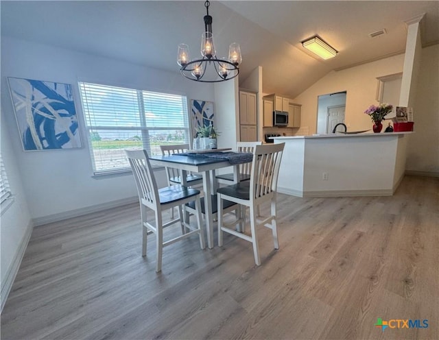 1806 Gigante Dr, Killeen, TX 76543 - dining space with a chandelier, light wood-type flooring, baseboards, and vaulted ceiling
