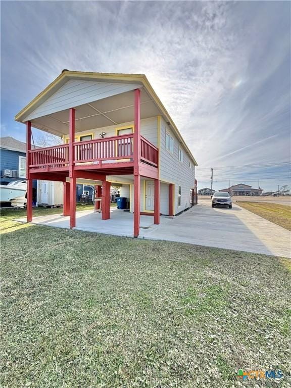 view of property exterior featuring a yard, a deck, and a patio