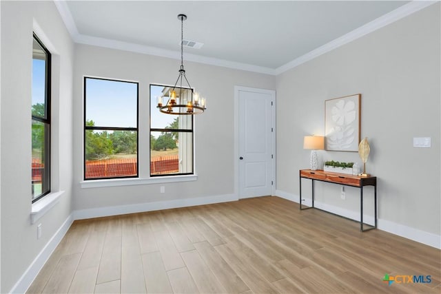 interior space featuring ornamental molding, light hardwood / wood-style floors, and a chandelier