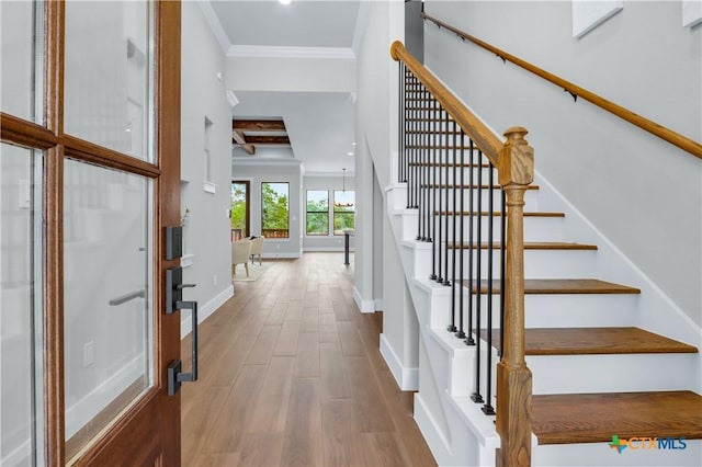 entryway featuring light hardwood / wood-style floors and ornamental molding