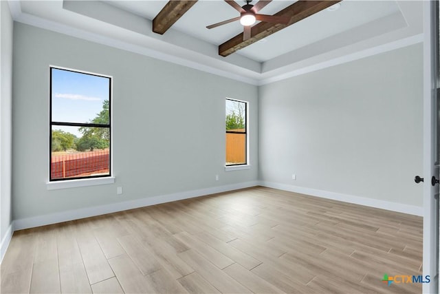 spare room featuring ceiling fan, light hardwood / wood-style flooring, a raised ceiling, and beamed ceiling