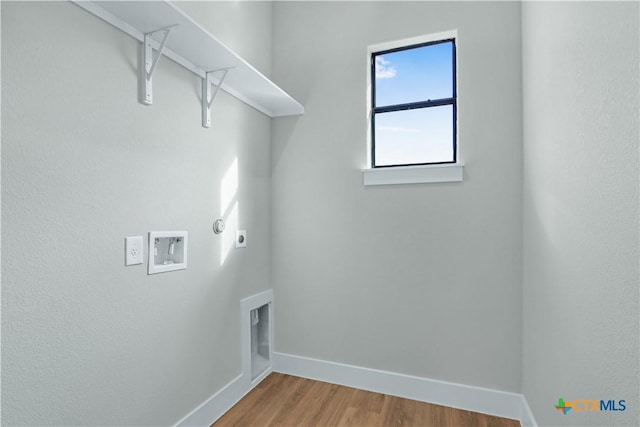 laundry area featuring gas dryer hookup, hookup for a washing machine, hookup for an electric dryer, and hardwood / wood-style flooring