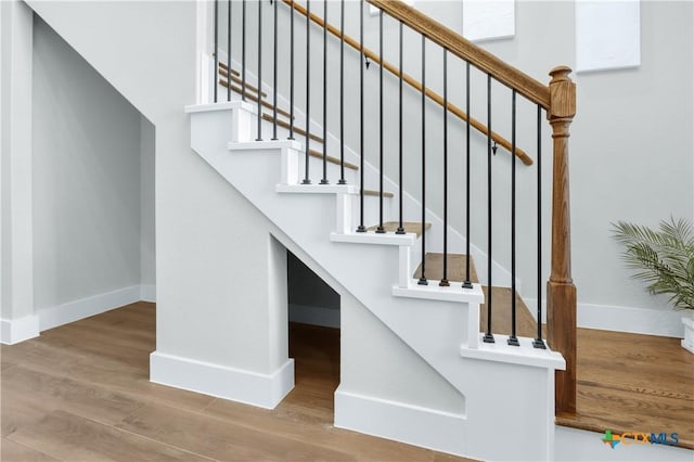 stairs featuring wood-type flooring