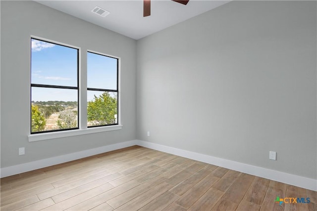 empty room featuring ceiling fan and light hardwood / wood-style floors