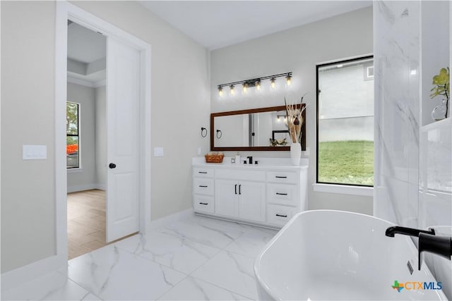 bathroom featuring vanity and a tub