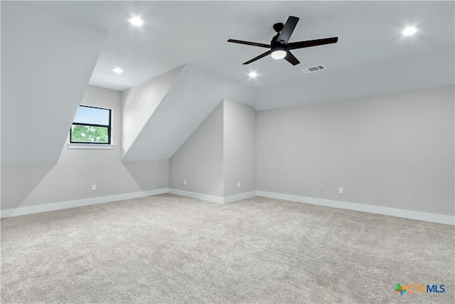 bonus room with lofted ceiling, light carpet, and ceiling fan