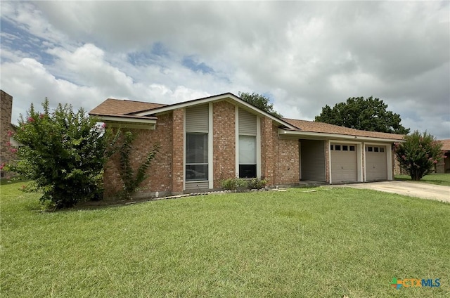 1804 Kingman Rd, Killeen, TX 76549 - view of front facade with driveway, a garage, brick siding, and a front yard