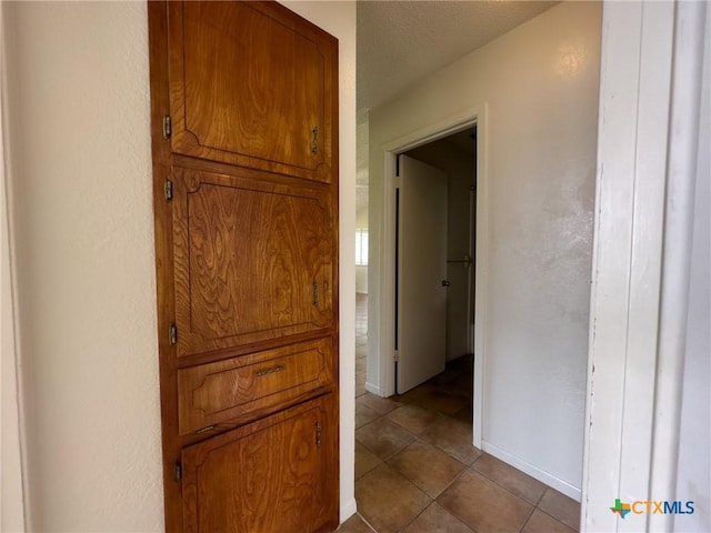1804 Kingman Rd, Killeen, TX 76549 - hall with dark tile patterned floors and a textured wall